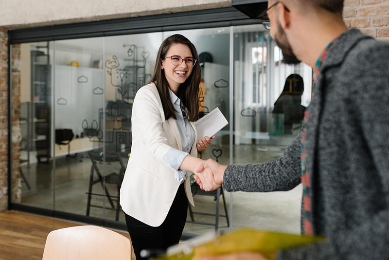 Job Interview Woman greets man at job interview